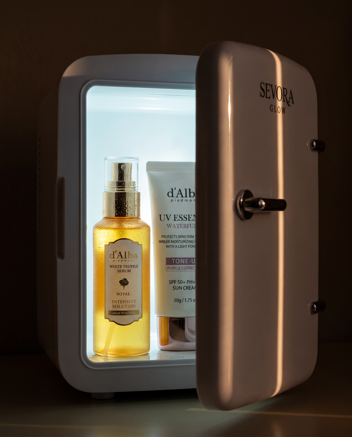 Open Sevora Glow Skin Cooler glowing inside, with a chilled d'Alba White Truffle serum and UV cream
